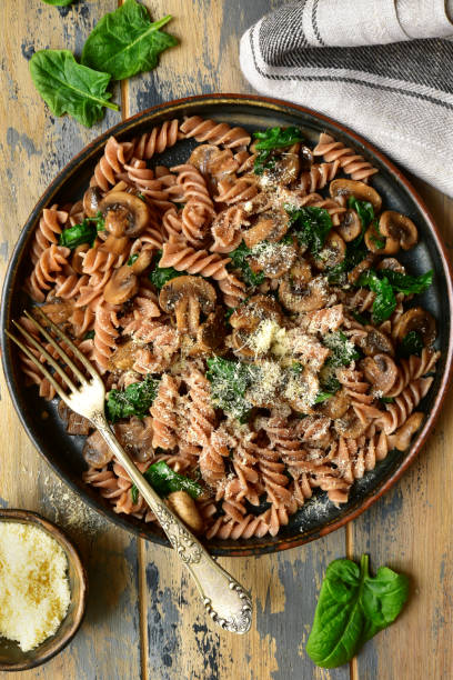 istock Whole wheat fusilli pasta with mushroom and spinach 1141310094