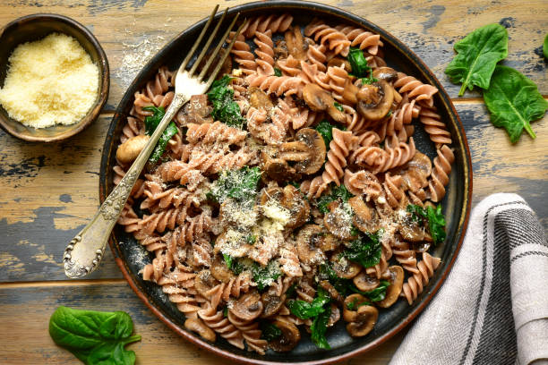 istock Whole wheat fusilli pasta with mushroom and spinach 1141310118