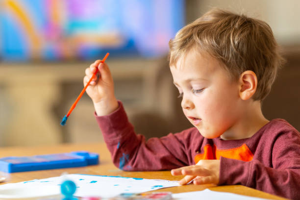 istock Three years old child painting with watercolors 1141314583