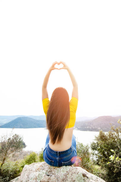 istock Woman making heart shape with hands in summer 1141315008