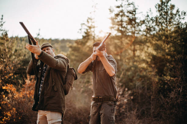 istock Couple of hunters, looking for birds 1141316972