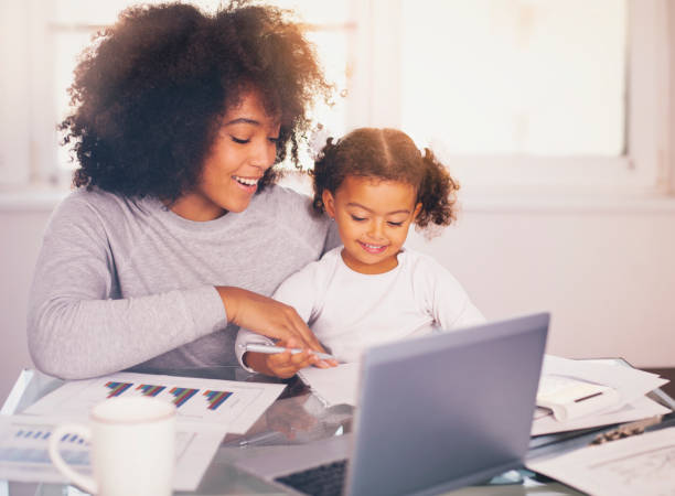 istock Young mother working and spending time with her daughter 1141319643