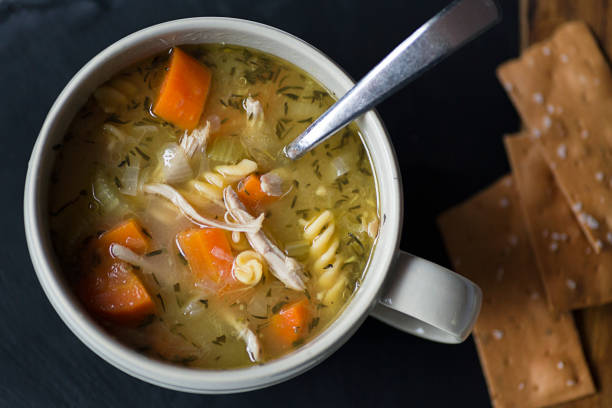 Chicken Noodle Soup Homemade chicken noodle soup with carrots and crackers noodle soup photos stock pictures, royalty-free photos & images
