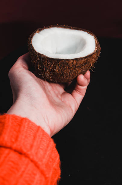 istock a half of coconut in the hand 1141323578