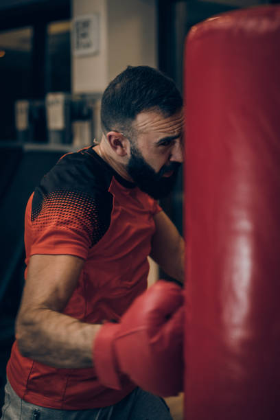 istock Handsome bearded boxer boxing in the gym 1141326661