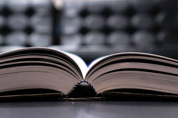 istock Reading old textbook in university library, read book or relaxing in vintage black background. Reading is complex cognitive process of decoding symbols to derive meaning communication information. 1141327496