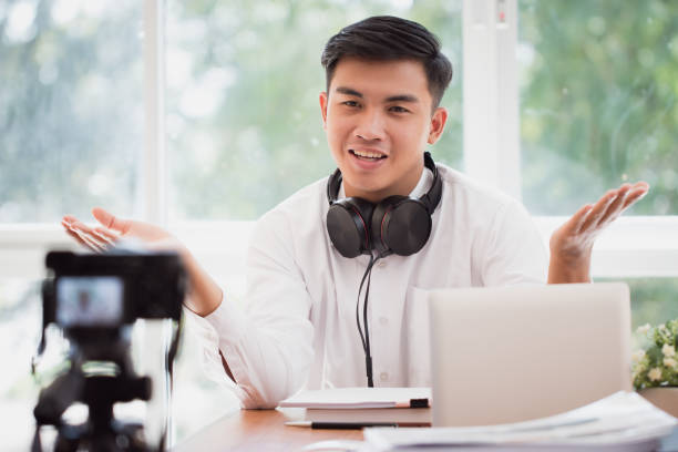 istock Happy Asian businessman videoblog / blogger vlogger recording online course or tutorial strategy presentation pass video for teaching live marketing sharing social media channel by mirrorless camera 1141327806