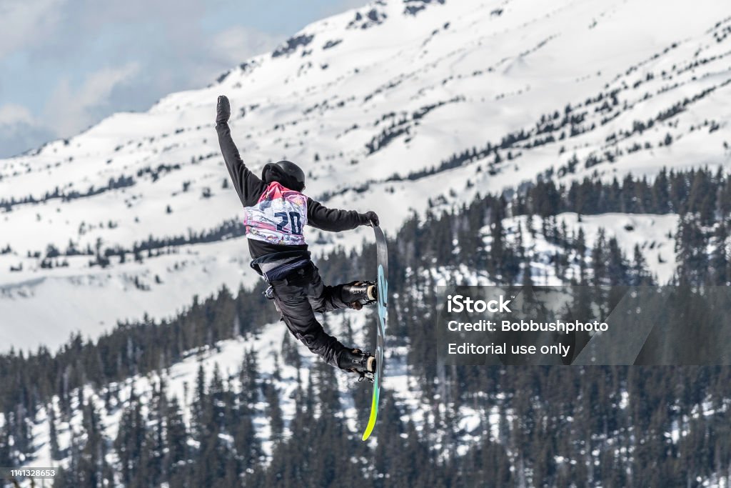 Big Air snow boarder competing  at Mount Bachelor in Oregon Jumpers and boarders compete at the Hella Big Air Competition in March, 2018 at Mt. Bachelor in Oregon Snowboard Stock Photo