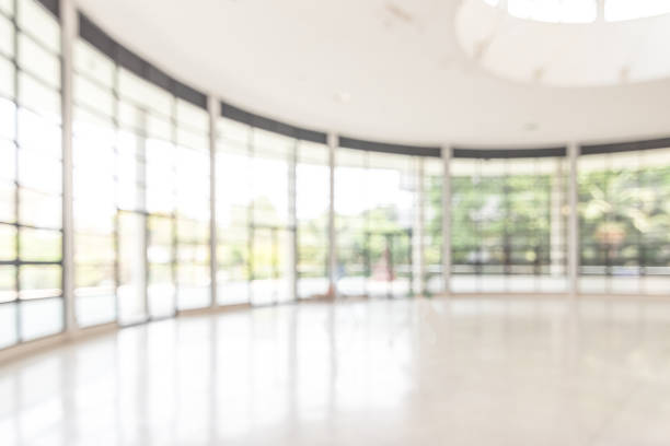 istock Blur background interior view looking out toward to empty office lobby and entrance doors and glass curtain wall 1141328947