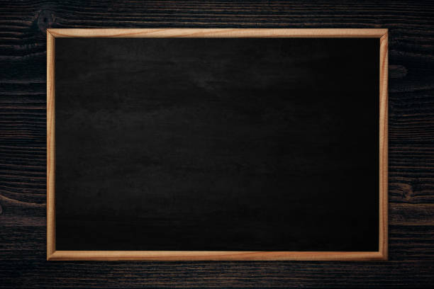 istock Abstract blackboard or chalkboard with frame on wooden background. 1141329263