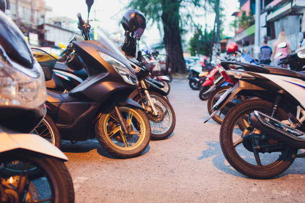 a series of motorbikes parked in a lot