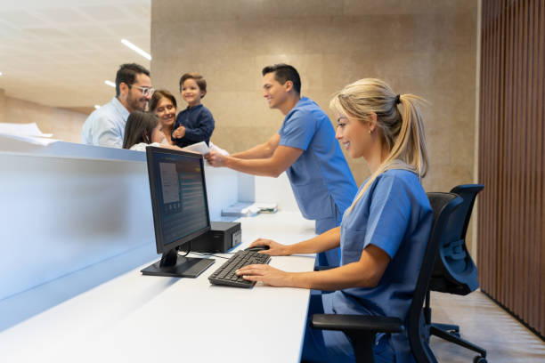 istock Dad with his two kids and grandmother signing forms before a pediatrics appointment 1141330761