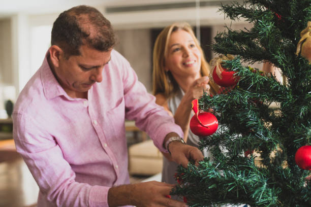 istock Family decorating the christmas tree 1141333472