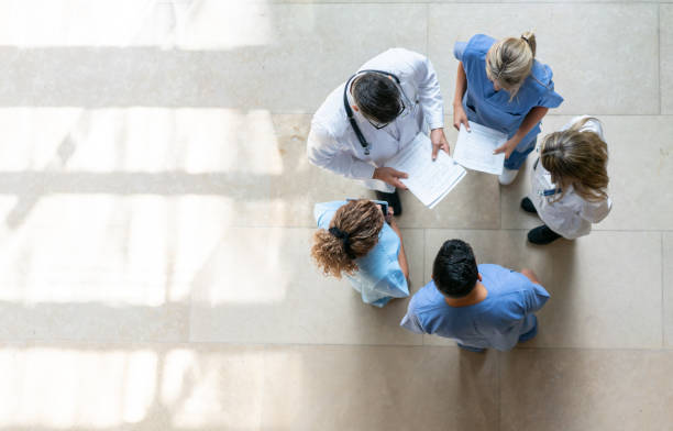 Healthcare professionals during a meeting at the hospital Healthcare professionals during a meeting at the hospital - High angle view general practitioner photos stock pictures, royalty-free photos & images