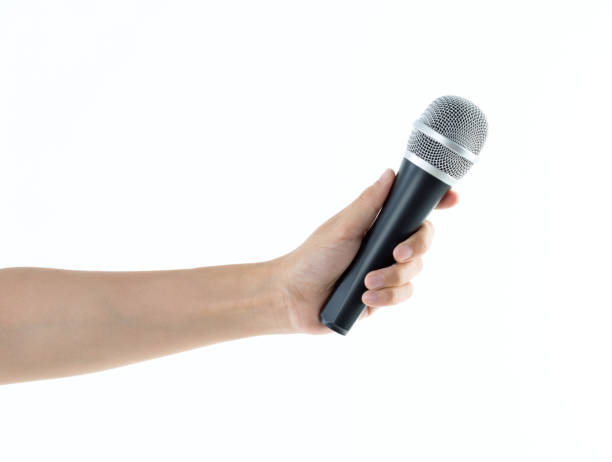 istock Woman hand holding a microphone on white background 1141337276