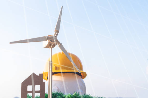istock Power renewable energy future alternative with panel green environment / sustainable development concept, Two engineer yellow white hat and home wind turbine on grass background. Ideas eco environment 1141338012