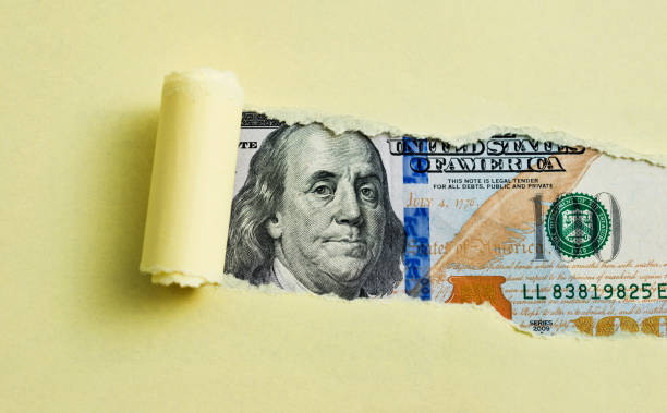 Tear paper appears US dollar bills Tear paper appears US dollar bills. benjamin franklin photos stock pictures, royalty-free photos & images