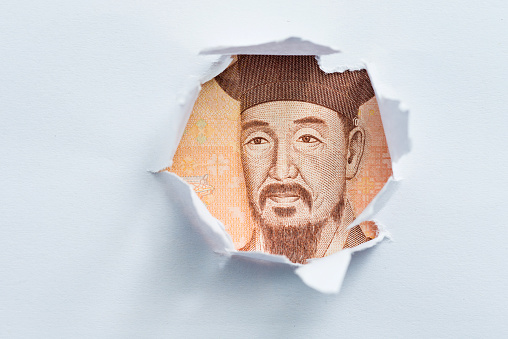 Korean currency in the hole of paper.