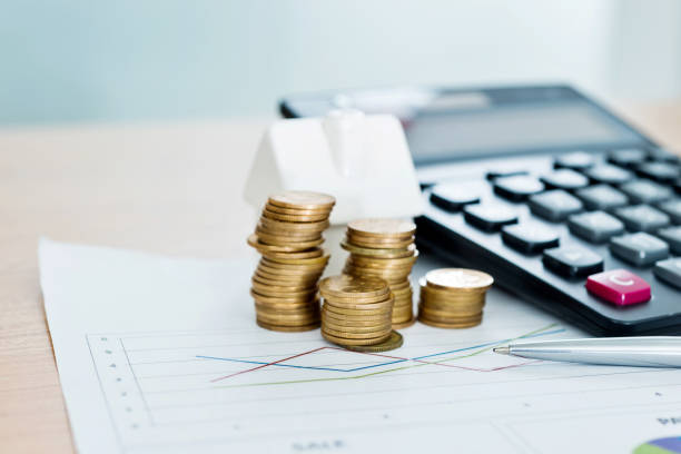 istock House model and stack of coins on office desk 1141340774
