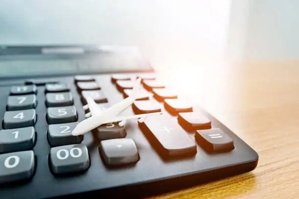 Photo of Model plane and calculator on wooden table