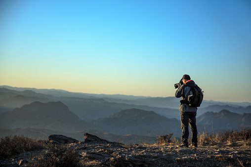 Photographer,Camera - Photographic Equipment,Discovery,Extreme Sports,
High Up,Mountain Range,On Top Of,Outdoors,Rock