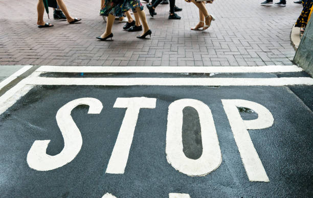 istock People walking on street with stop sign 1141343542