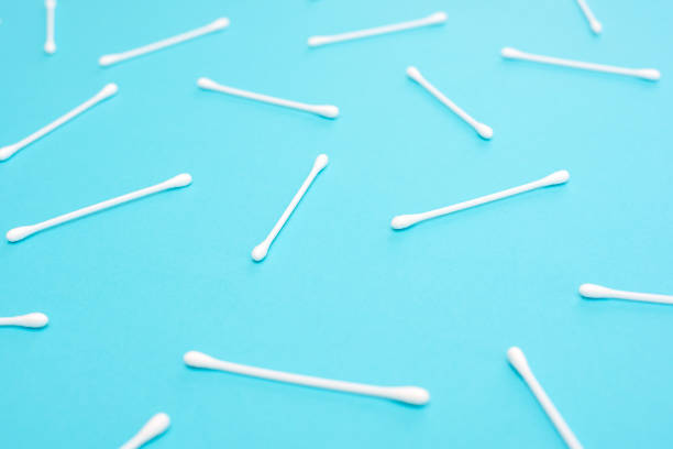 istock White cotton swabs on blue background lie in random order 1141344479