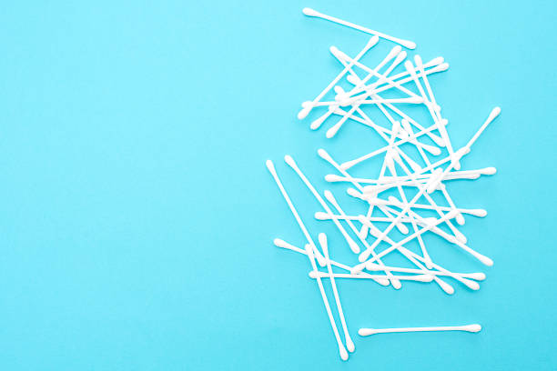 istock White cotton buds scattered on blue background 1141344537