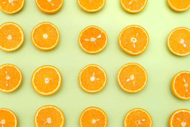 istock Orange juicy oranges split in half on green 1141345030