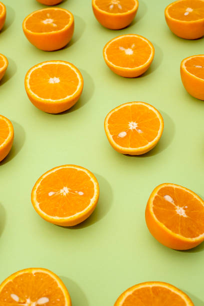 istock Orange juicy oranges split in half on green 1141345550