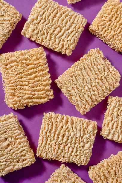istock Instant noodles on purple lie next to each other 1141345596