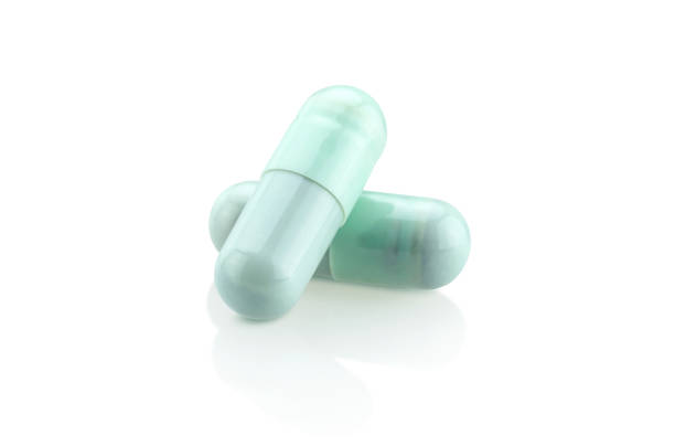 istock blue medicine capsules isolated on white background 1141345973