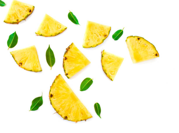 motif d’été avec des tranches d’ananas d’isolement. fruits exotiques ananas morceaux avec des feuilles de menthe verte sur fond blanc. plat couché. - ananas photos et images de collection