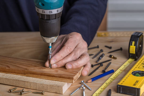 istock Carpenter with an electric screwdriver. carpenter at handmade work 1141347745
