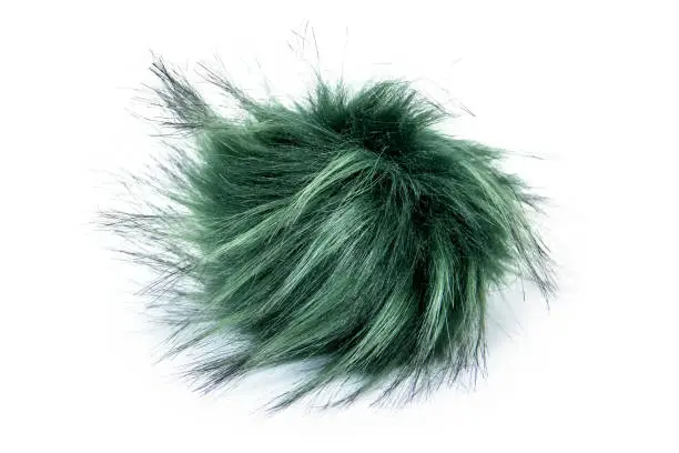 Photo of Fur ball isolated on white background. Green fur ball isolated