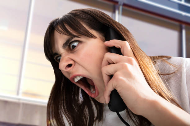istock Frustrated Woman Shouting On Telephone 1141353570