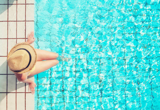 istock Young woman relaxing in swimming pool 1141353650