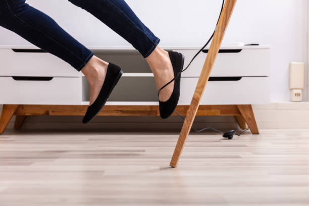 istock Woman Legs Stumbling With An Electrical Cord 1141353711