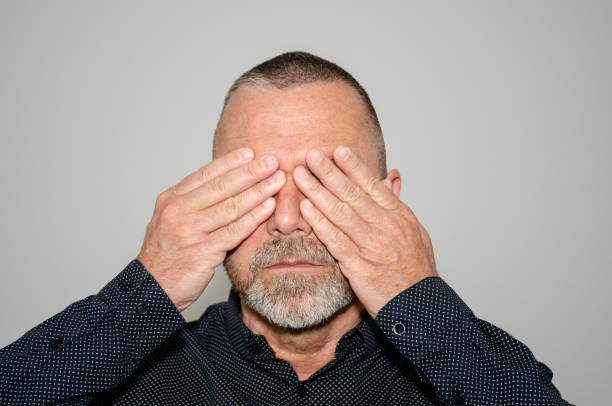 istock Middle-aged bearded man covering his eyes 1141353889