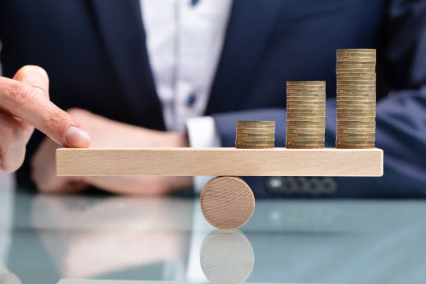 istock Businessperson Balancing Increasing Stacked Coins With Finger 1141354705