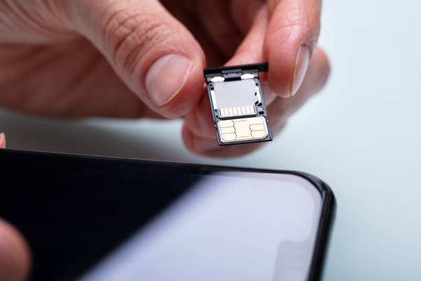 istock Person Inserting Sim Card In Cellphone 1141354719