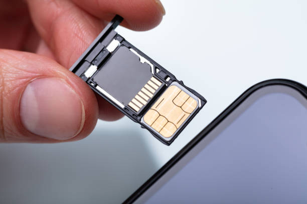 istock Person Inserting Sim Card In Cellphone 1141354722