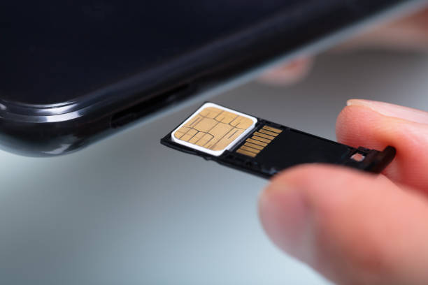 istock Person Inserting Sim Card In Cellphone 1141354729