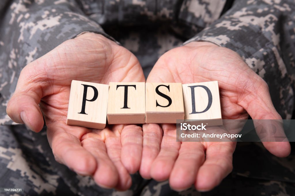 Male Soldier Holding Wooden Cubes With PTSD Text Close-up Of Male Soldier In Military Uniform Holding Wooden Cubes With PTSD Text Post-traumatic stress disorder Stock Photo