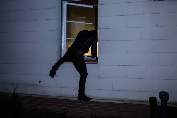 istock Burglar Entering In A House Through A Window 1141354818