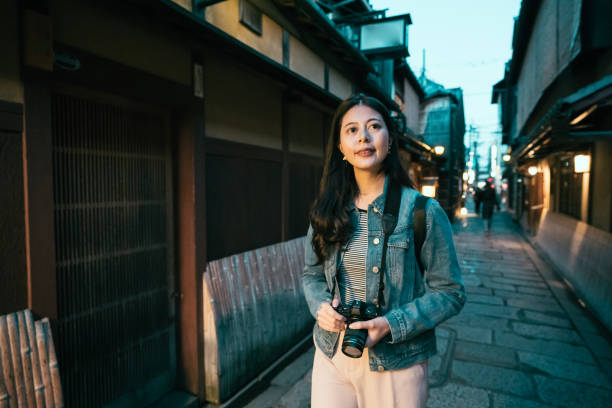istock asian lady shooting by camera in dark passway 1141355166