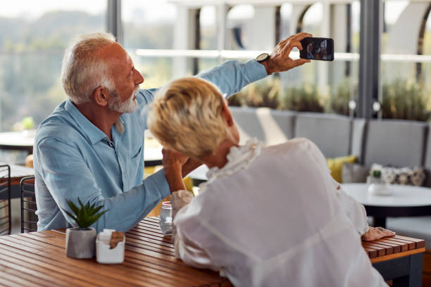 istock Senior Couple Making Selfie In Rooftop Cafe 1141360182