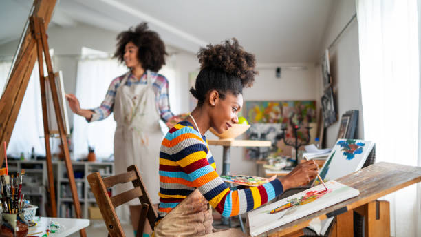istock Afro Female fine artists drawing in studio 1141361535