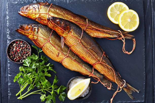 istock smoked herrings on a black slate tray 1141361839