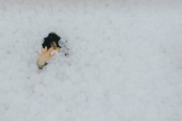 asian woman show her hand with white ball pit - ball pool imagens e fotografias de stock